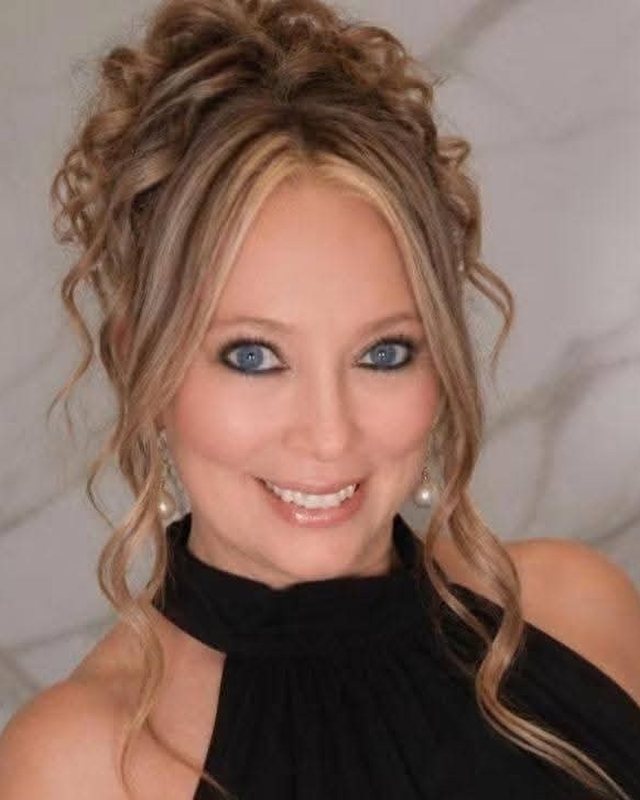 Portrait of Denise Tara Rivera, smiling