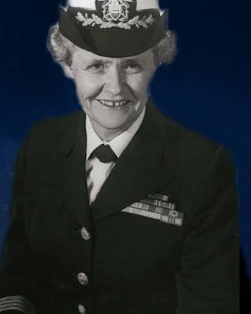 Kay Keating in her U.S. Navy dress uniform and officer's cap, smiling
