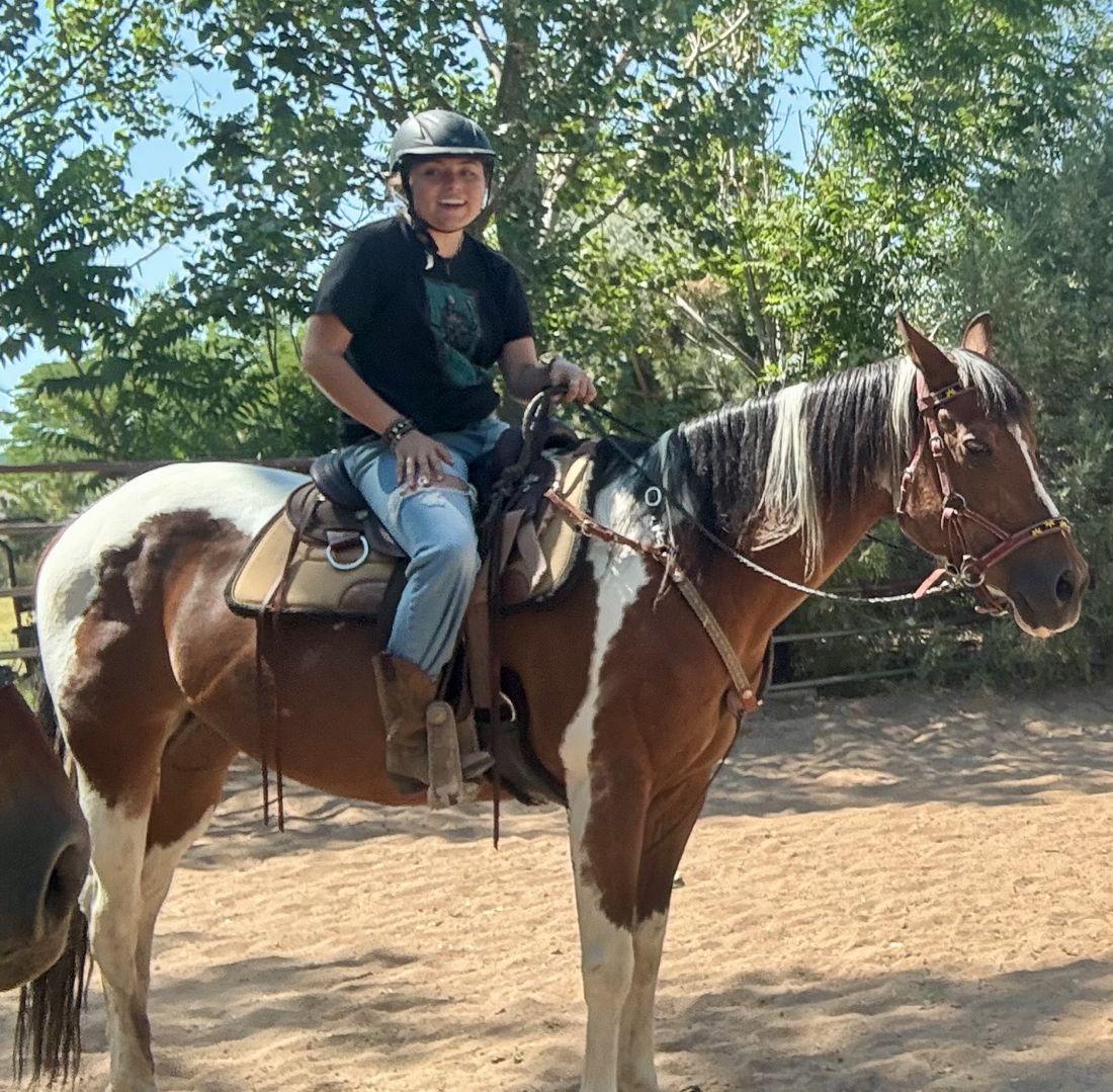 Eloisa, a Mane Joy Peer Leader, riding Bourbon in a Western saddle at SonFlower Ranch